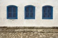 Three wood windows in a house facade at Paraty, Brazil