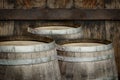 Three wooden barrels near old textured wall Royalty Free Stock Photo