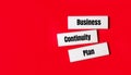 Three wooden blocks with the text BCP Business Continuity Plan on a bright red background. Copy space Royalty Free Stock Photo