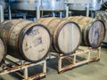 Three wooden cider barrels in a warehouse in Corvallis, Oregon