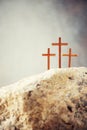 Three wooden cross on Calvary hill, grey background. Crucifixion, resurrection of Jesus Christ. Christian Easter holiday Royalty Free Stock Photo