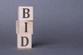 Three wooden cubes with letters BID, business and financial concept Royalty Free Stock Photo