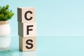 three wooden cubes with letters cfs - short for consolidated financial statement, concept