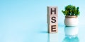 Three wooden cubes with letters HSE - short for Higher School of Economics, concept