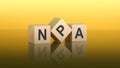 Three wooden cubes with the letters NPA on the bright yellow surface. the inscription on the cubes is reflected from the