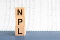 Three wooden cubes with letters NPL - short for Non Performing Loans, concept