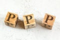 Three wooden cubes with letters PPP stands for Praise Picture Push on white board.