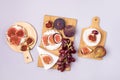 Three Wooden Cut Boards with Snacks for Wine Hardtack with Figs Brie Cheese and Grape on Wooden Board Blue Background Top View Royalty Free Stock Photo