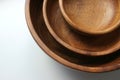 Three wooden empty food bowls stacked on top of each other