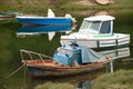 Three wooden fishing boats stranded in an estuary (Ortigueira, Spain)