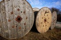 Three wooden coils with industrial cables outdoors Royalty Free Stock Photo