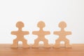 Three wooden mannequins stand on the table. teamwork. Royalty Free Stock Photo