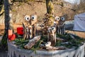 Three wooden owls on a decorated table.
