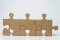 Three Wooden pieces of jigsaw puzzle with white background and selective focus Royalty Free Stock Photo