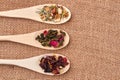 Three wooden spoons with assorted tea leaves. Royalty Free Stock Photo