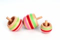 Three wooden tippe tops on white background Royalty Free Stock Photo