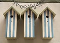 Three wooden white and blue birdhouses