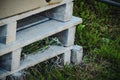 Three wooden white painted palettes stacked on green grass Royalty Free Stock Photo