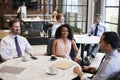 Three work colleagues talking at their office cafe Royalty Free Stock Photo