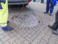 Three worker by the closed man hole cover