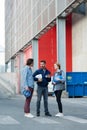 Three workers stood by factory loading bays