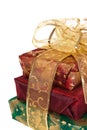 Three wrapped gift boxes with gold ribbon and bow