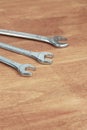 Three wrenches lies on a wooden surface hand tool copy space Royalty Free Stock Photo