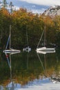 Three yachts on Lake Bohinj in Slovenia. Alps and autumn forest