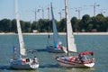 Three yachts moving in the same direction along the rive