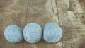 Three yarn balls on a wooden background. Royalty Free Stock Photo