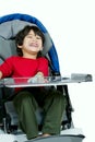Three year old biracial disabled boy in medical stroller, happy Royalty Free Stock Photo