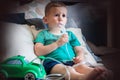 Three year old boy making inhalation with nebulizer at home Royalty Free Stock Photo
