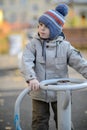 three-year-old boy rides a swing on the playground Royalty Free Stock Photo