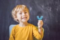 Three-year old boy shows myofunctional trainer. Helps equalize t Royalty Free Stock Photo