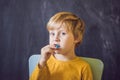 Three-year old boy shows myofunctional trainer. Helps equalize the growing teeth and correct bite, develop mouth Royalty Free Stock Photo