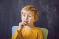 Three-year old boy shows myofunctional trainer. Helps equalize t Royalty Free Stock Photo