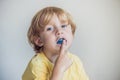 Three-year old boy shows myofunctional trainer to illuminate mouth breathing habit. Helps equalize the growing teeth and correct Royalty Free Stock Photo