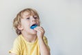 Three-year old boy shows myofunctional trainer to illuminate mouth breathing habit. Helps equalize the growing teeth and correct Royalty Free Stock Photo