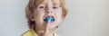 Three-year old boy shows myofunctional trainer to illuminate mouth breathing habit. Helps equalize the growing teeth and Royalty Free Stock Photo