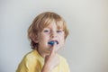 Three-year old boy shows myofunctional trainer to illuminate mouth breathing habit. Helps equalize the growing teeth and correct b Royalty Free Stock Photo