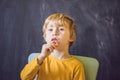 Three-year old boy shows vestibular plate. Plate with a bead to Royalty Free Stock Photo