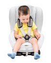 Three-year-old boy sits in an automobile children`s chair Royalty Free Stock Photo