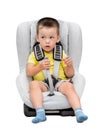 Three-year-old boy sits in an automobile children`s chair Royalty Free Stock Photo