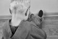 A three-year-old caucasian boy sits alone on the floor and hugs teddy bear Royalty Free Stock Photo