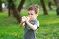 Three year old caucasian toddler boy drinks water from a bottle in the park Royalty Free Stock Photo