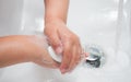 Child washing hands with soap