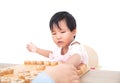 A three-year-old Chinese girl in front of a white background is playing Chinese chess Royalty Free Stock Photo