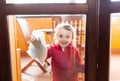 Three year old girl helps with housekeeping by cleaning the windows