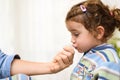 A three-year-old girl spits into a saliva test tube for covid19 antigens