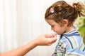 A three-year-old girl spits into a saliva test tube for covid19 antigens